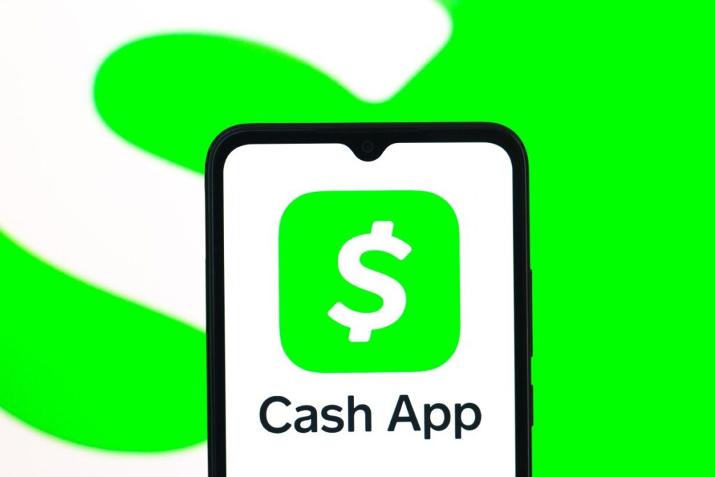 In this photo illustration, the Cash App logo is seen displayed on a smartphone screen.