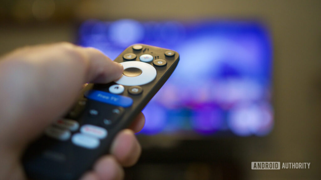 Someone using the remote for the Onn 4K Pro (2026).