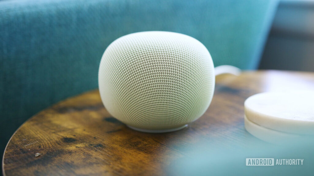Google Home Speaker sitting on an end table.
